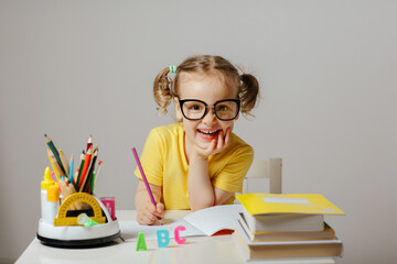 child and education, homework and school concept, positive and cheerful smiling student girl with...