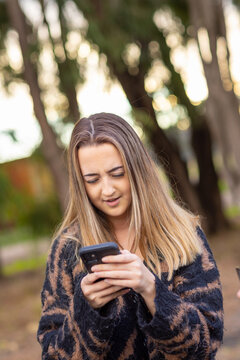 teen girl holding smartphone and looking at it