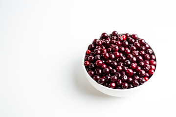 Ripe cherry on a white background. Place for the inscription in your article about the benefits of berries during beriberi.