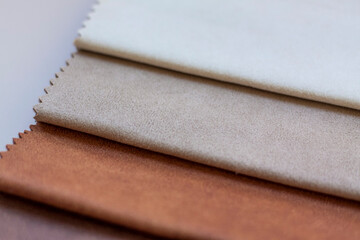 Backgrounds made of natural and artificial fabrics for the decoration of textiles, furniture and clothing on a beige background. Furniture production. wallpaper with space for copying text.