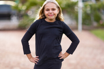 indigenous child in confident stance with hands on hips