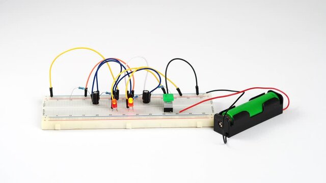 Multivibrator assembled on breadboard board on a white background.