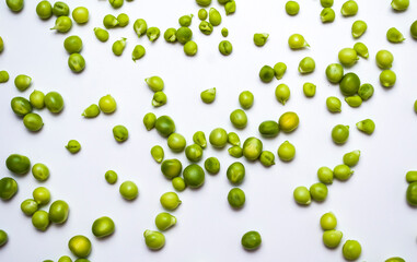 Scattered peas on a white background, Screensaver or article about the benefits of green peas in the human diet.
