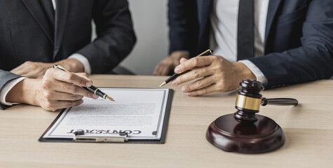 Two male lawyers are consulting together to draft a contract acknowledgment for their clients, they form partnerships to open a law firm. The idea of opening a law firm to accept the lawsuit.