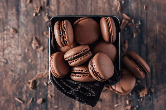 Chocolate macarons on wooden table