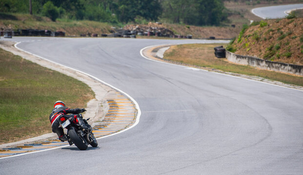 man practising laps on race track with his motorcycle