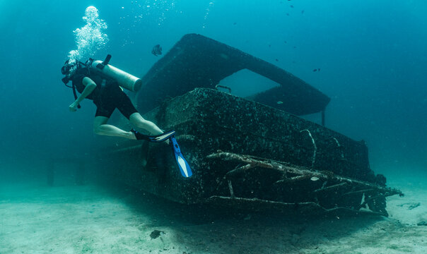 diver exploring ship wreck  on the ocean floor at Phuket