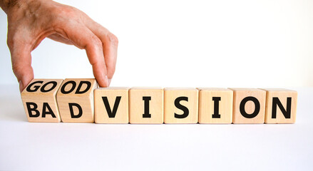Good or bad vision symbol. Businessman turns cubes and changes words 'bad vision' to 'good vision'. Beautiful white table, white background, copy space. Business, good or bad vision concept.