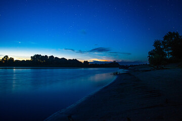 Fototapeta na wymiar Night river and starry sky