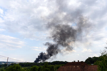Dark black smoke in the sky, summer landscape, fire in Košice