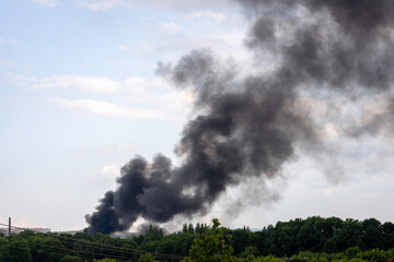 Dark black smoke in the sky, summer landscape, fire in Košice