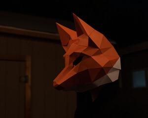 Selective focus of a person wearing a low poly fox mask