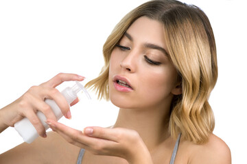 Beautiful young woman uses soap, gel, cream or hand cleansing sanitizer liquid. Hygiene and skin care. Infection prevention. Selective focus