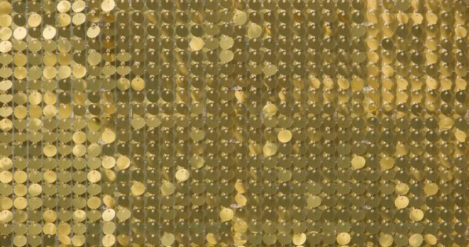 rows of blinking golden yellow brass metal plaques sway in wind and shines in sun and create unique pattern of movement. round reflective particles texture glitter under waves of wind. Spangle Glitter