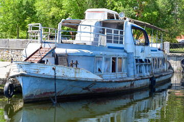 An old boat on the pier of the city embankment