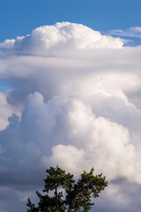 Dense thunderclouds among the blue sky.