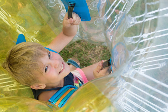A child in a bumperball. Portrait of a happy laughing child. Happiness, fun and laughter