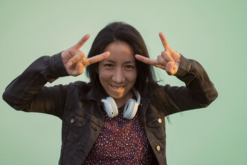 rocker woman making horns with her hands