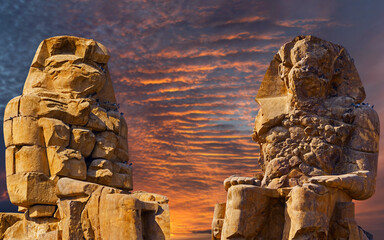 Colossi of Memnon Luxor Thebes against the background of dawn in the Egypt