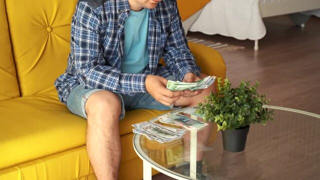 a man sitting at the table counting money