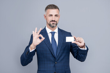 all is perfect. businessman demonstrating credit or debit card. empty plastic business name card.