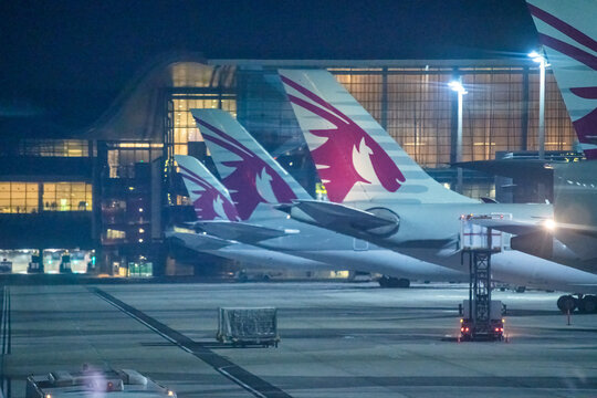 DOHA, QATAR - AUGUST 17, 2018: Qatar airlines aircrafts in Doha Airport at night.