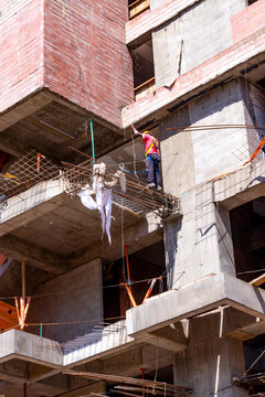 man working in construction on the heights of a building