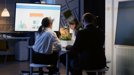 Focused businessman presenting company strategy using presentation monitor working in business...