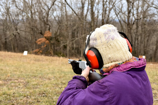 a woman target practicing in the winter