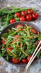 Delicious salad bowl with arugula, carrots and tomatoes.