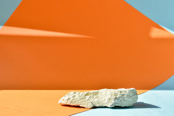 The podium is an orange-blue background with a stage, a showcase made of stone and a minimalistic...