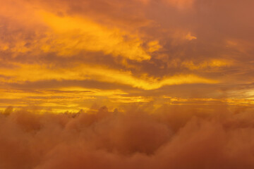 Fototapeta na wymiar view to soft yellow sky above fluffy clouds