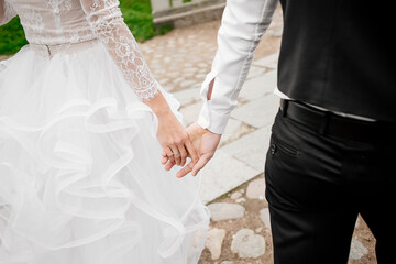Fototapeta na wymiar The bride and groom hold hands