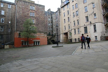 Walking across the square in Edinburgh, Scotland. The writer's museum is to the left of the couple...