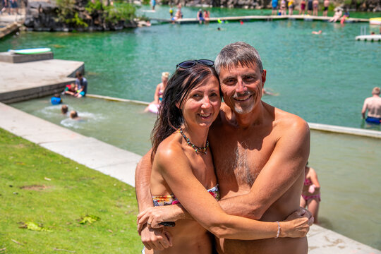 Happy couple relaxing and refreshing in summer season at a natural river pool.