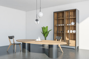 View of light white dining room space with cupboard from windows side