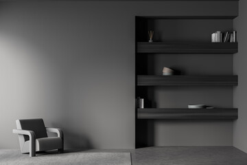 Armchair in the dark grey waiting room with niche bookshelf