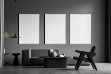 Modern living room interior with grey concrete floor and big window. Three mock up empty posters on the wall. Concept of contemporary design.