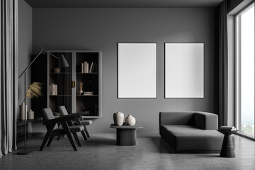 Modern living room interior with grey concrete floor and big window. Two mock up empty posters on...