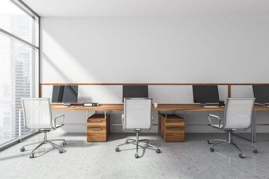 Three workplaces in the white panoramic office