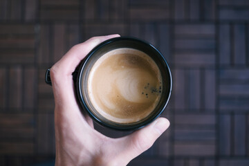 hand holding a cup of coffee