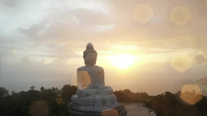 aerial panorama view scenery yellow sun with rain clouds moving..beautiful Phuket big Buddha on the top of mountain.. Another incentive to attract tourists to visit. popular landmark of Phuket
