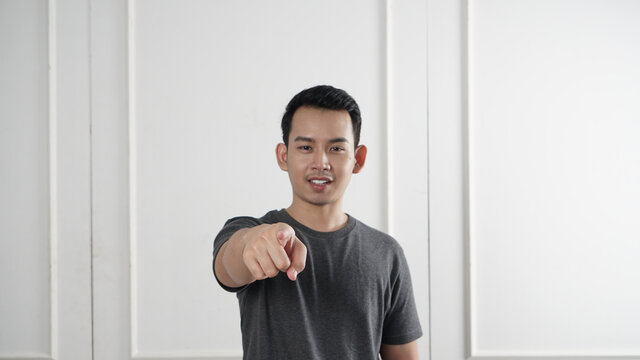 Asian man pointing to the front