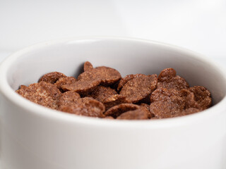 Cocholate cereal with milk on a white bowl