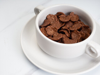 Cocholate cereal with milk on a white bowl