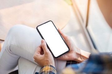 cell phone blank white screen mockup.woman hand holding texting using mobile on desk at...