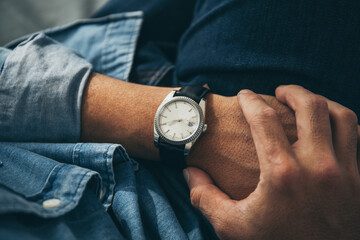 fashionable wearing stylish looking at luxury watch on hand check the time .concept for managing time organization working,punctuality,appointment