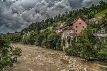 Fototapeta premium thunderstorn over a swiss landscape with a flooded river 