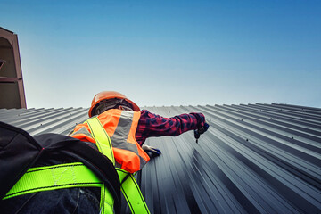 Worker man building tradesman on the roof of a house . with safety helmet, new home, construction concepts - Selective focus..vintage film grain filter effect styles © Chanwit