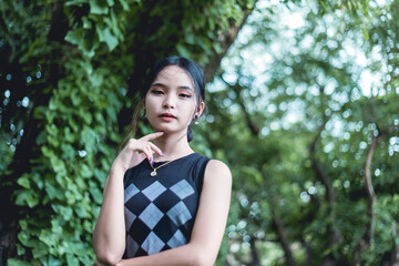A cute and petite lady of Chinese and Filipino descent. Posing at the park.